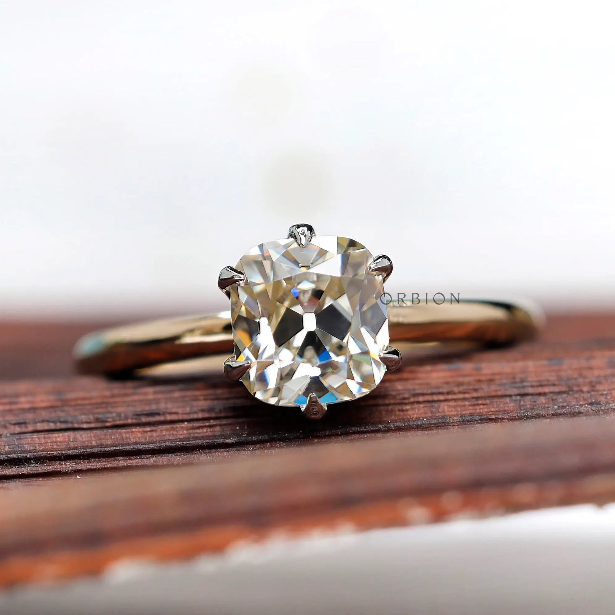 Front view of OMC elongated cushion moissanite two tone ring