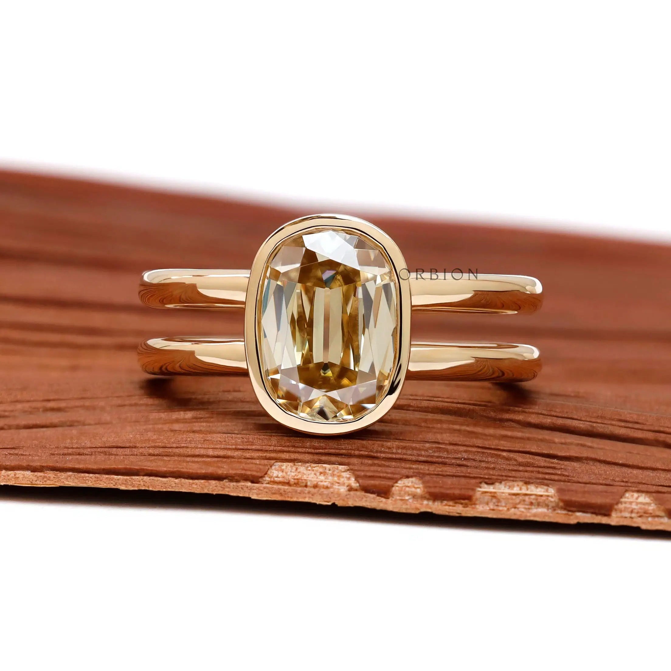 Front view elongated cushion champagne moissanite bezel ring gold