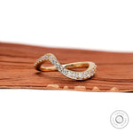 Front view of curved diamond wedding band in yellow gold