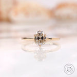 Front view of elongated cushion off white moissanite ring in yellow gold
