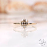 Front view of elongated cushion off white moissanite ring in yellow gold