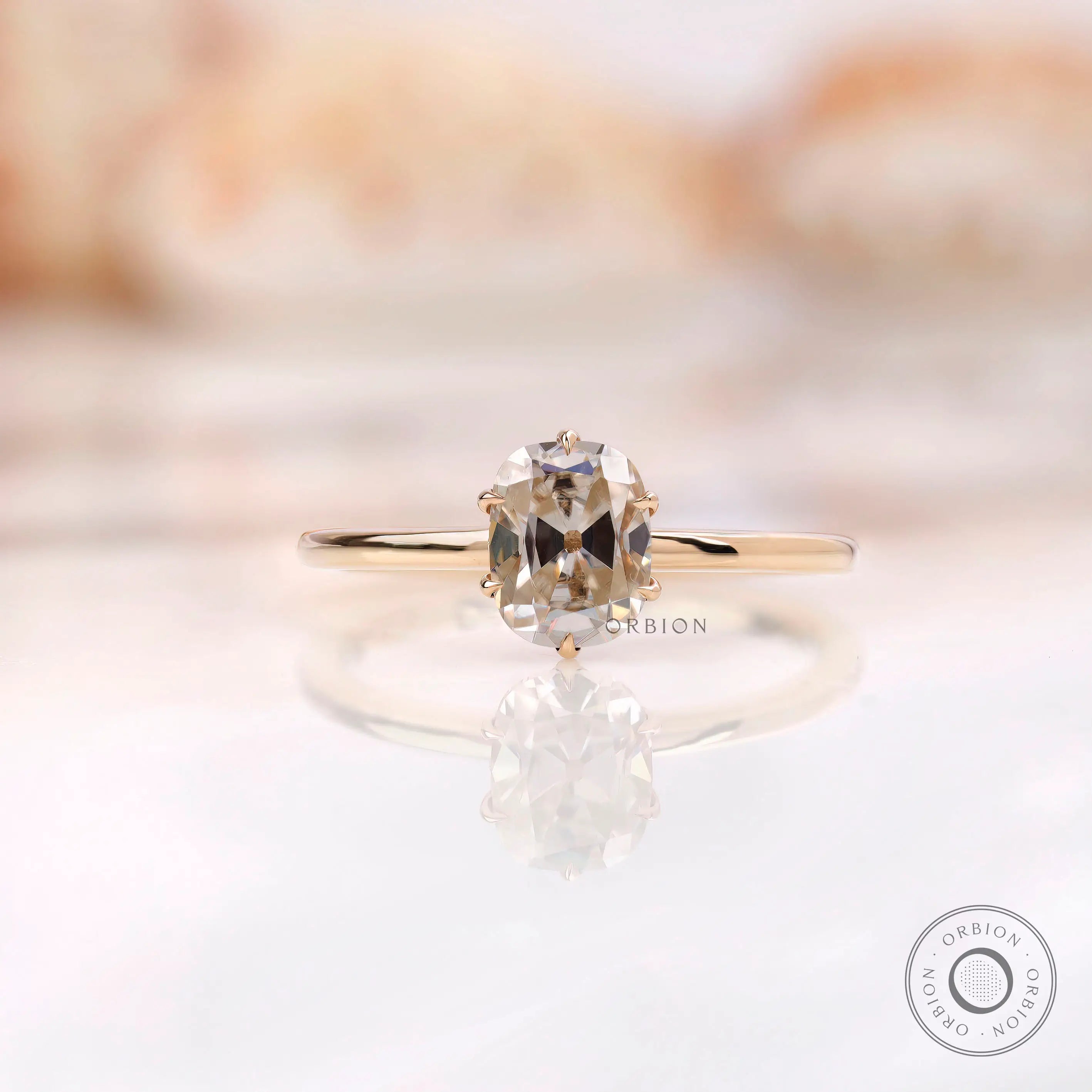 Front view of elongated cushion off white moissanite ring in yellow gold