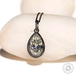Front view of pear moissanite pendant in oxidized silver