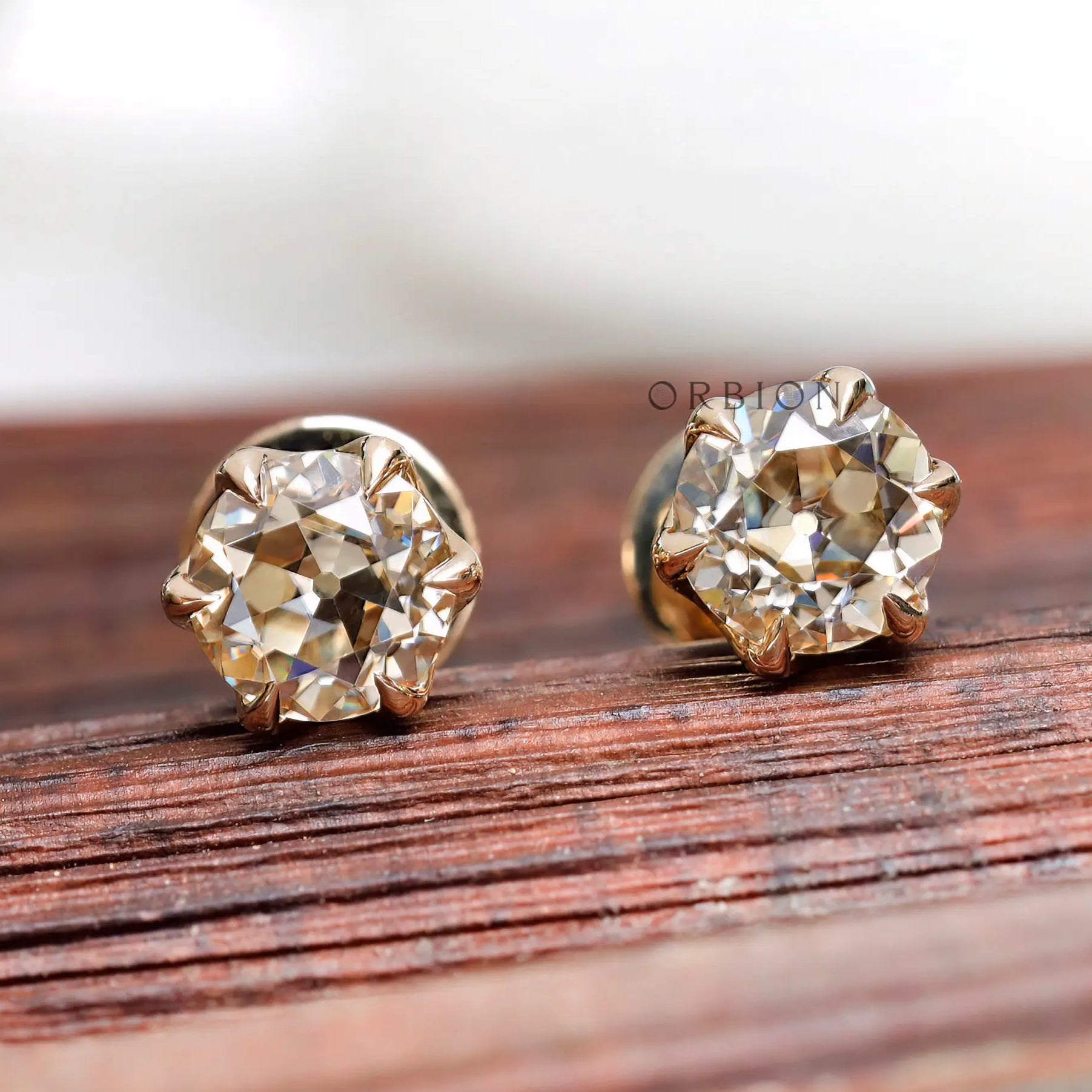 Close front OEC champagne moissanite stud earrings yellow gold