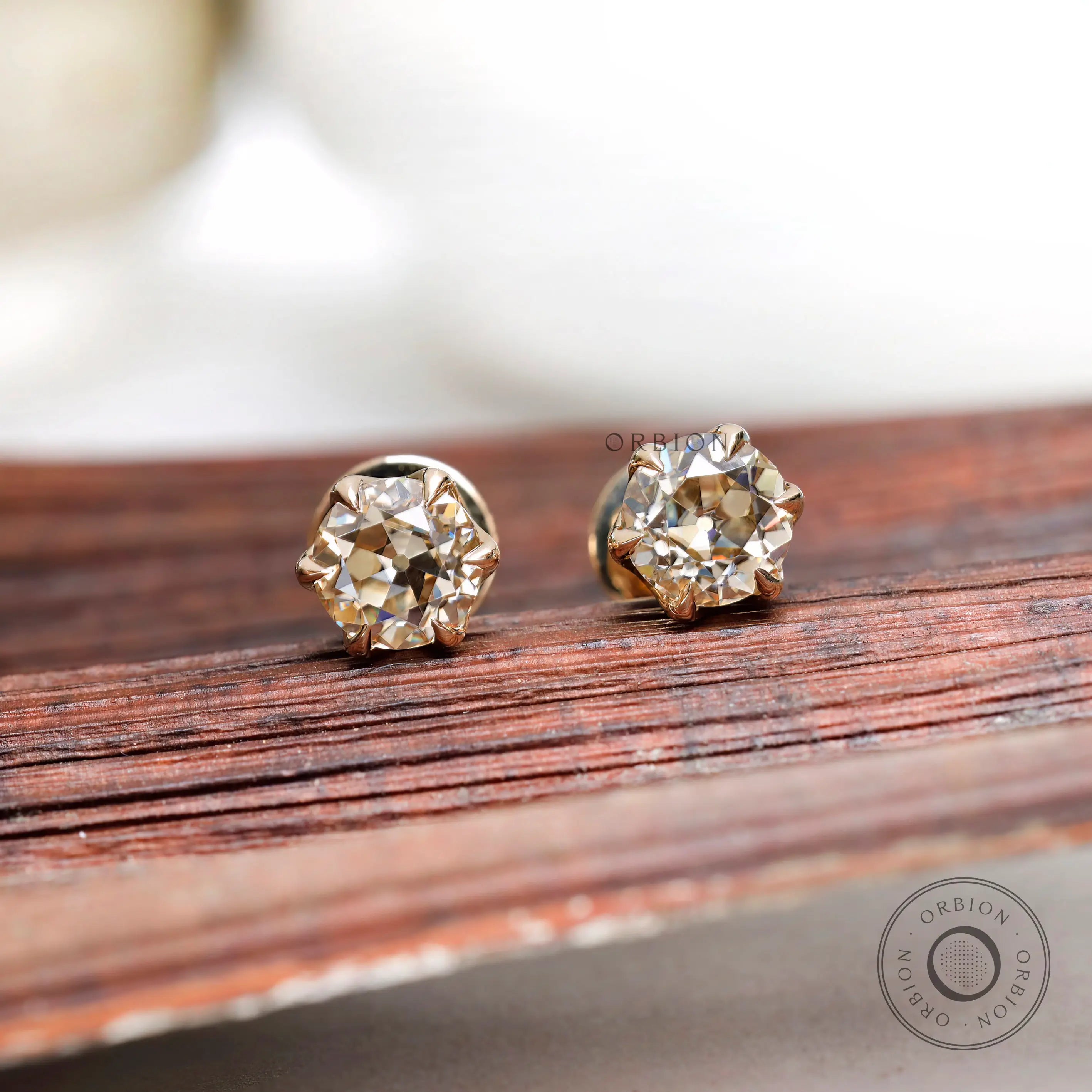 Close front OEC champagne moissanite stud earrings yellow gold