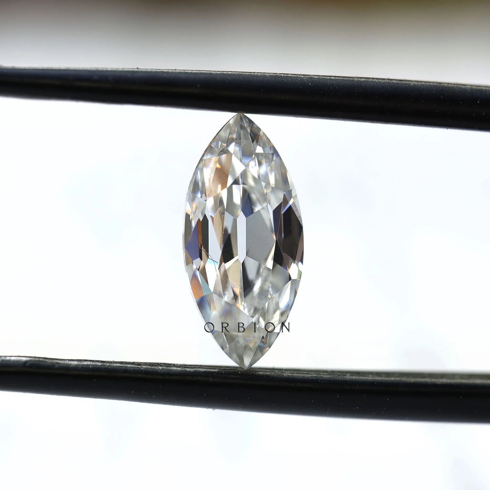 1.26 ct marquise loose moissanite stone in tweezers