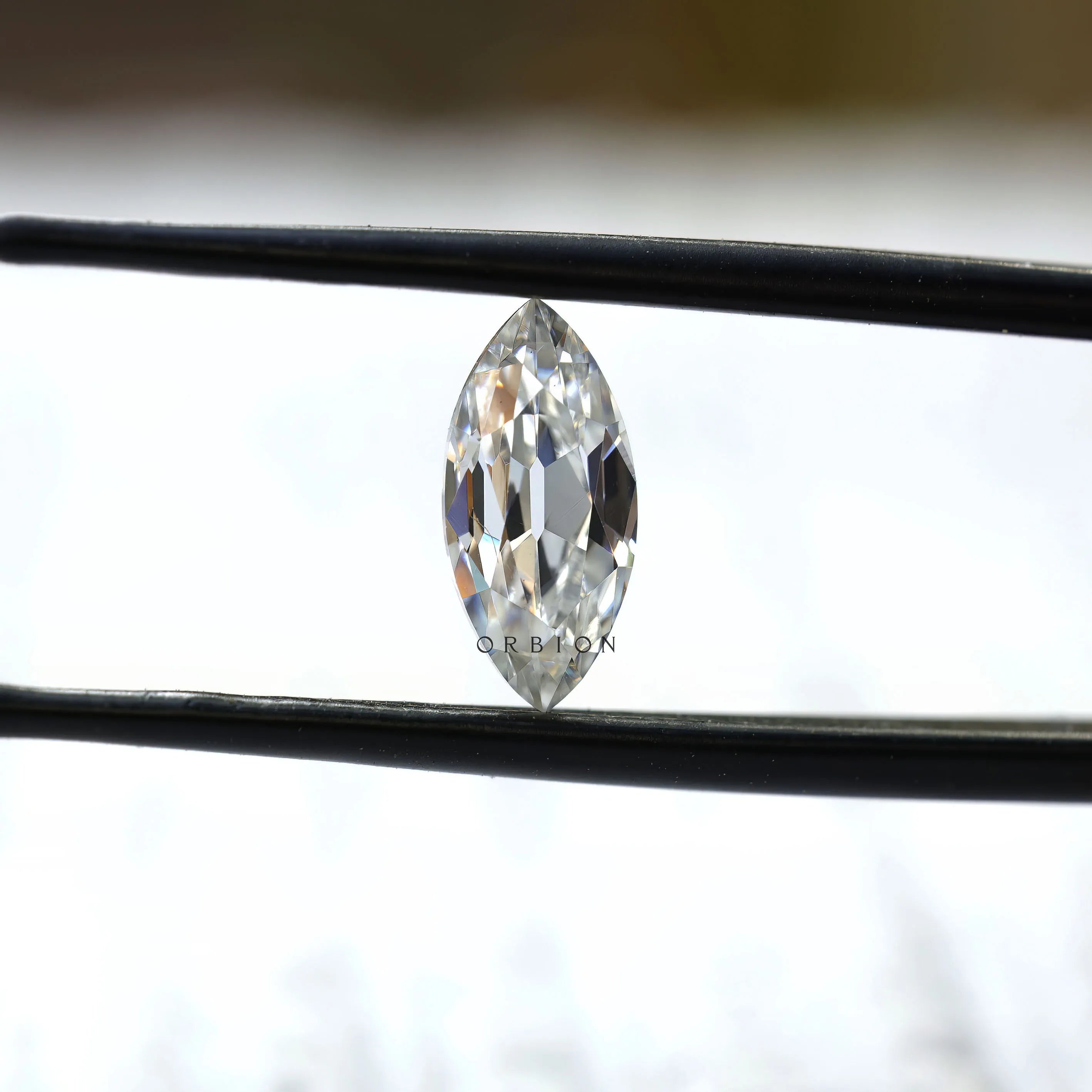 1.26 ct marquise loose moissanite stone in tweezers