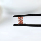 Fancy vivid pink radiant pair held in black tweezers