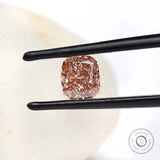 Fancy pink elongated cushion lab diamond held in black tweezers