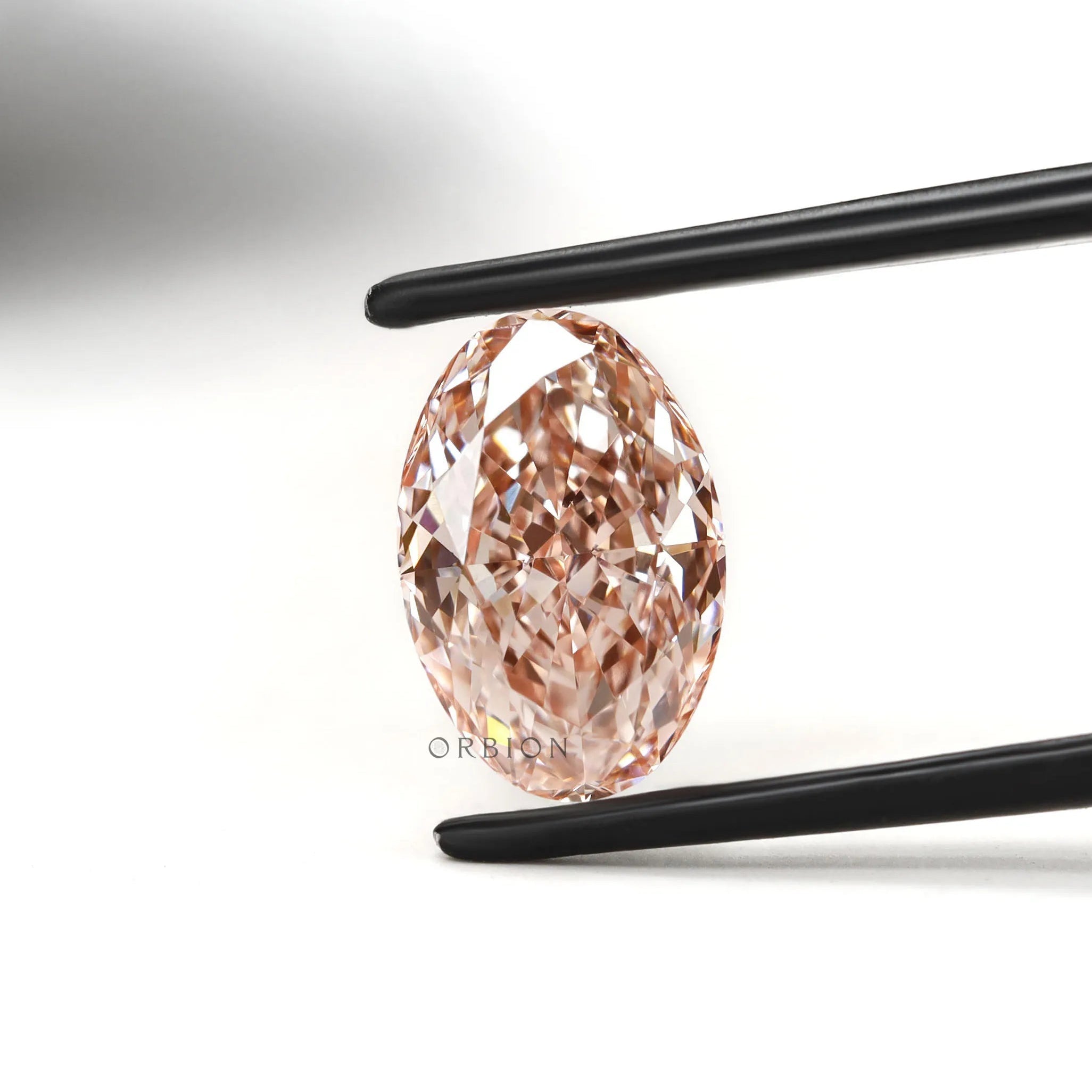 Close view of intense pink oval diamond with crisp faceting