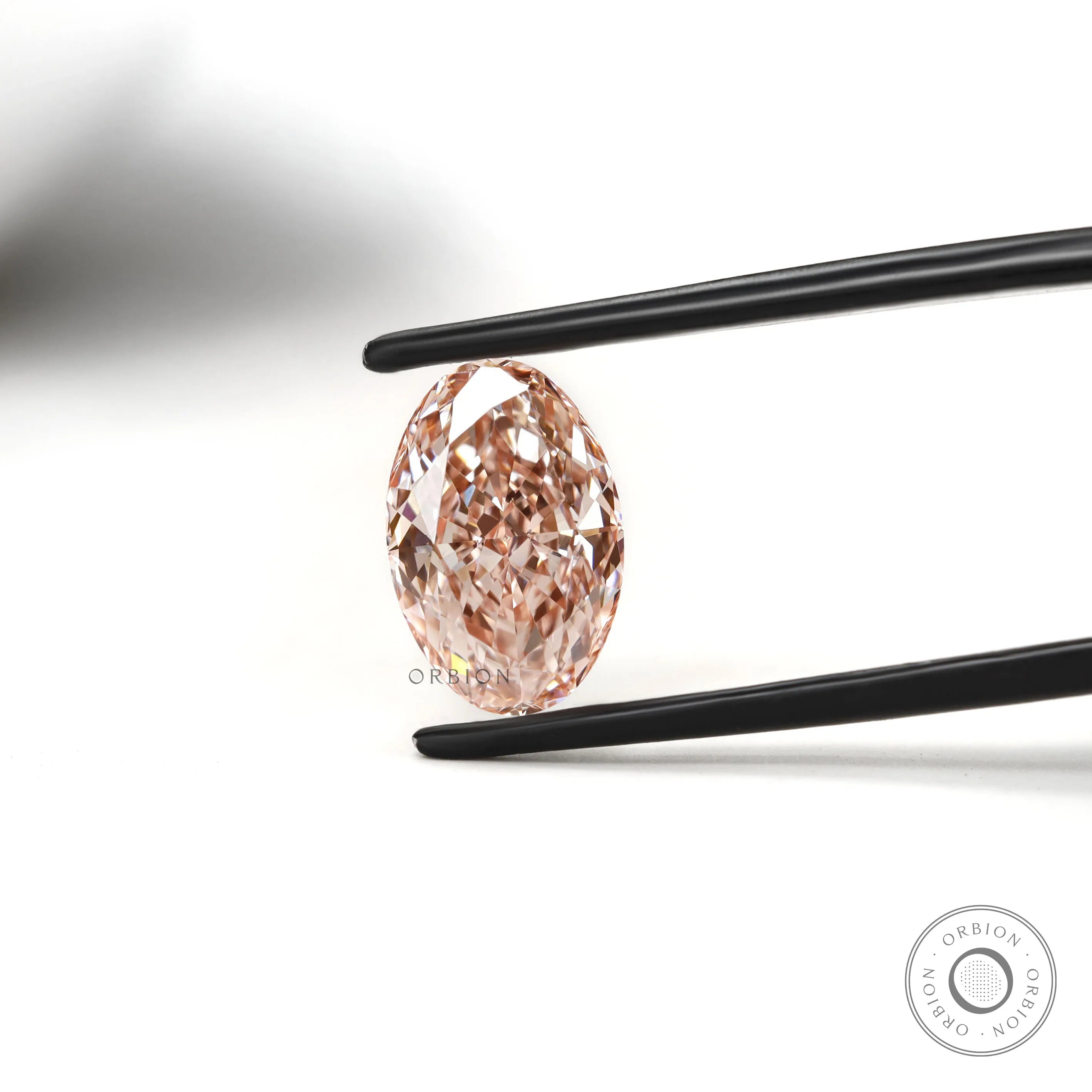 Close view of intense pink oval diamond with crisp faceting