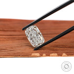 Elongated cushion crushed ice lab diamond held in black tweezers