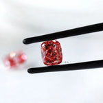 Fancy vivid pink cushion lab diamond pair in black tweezers
