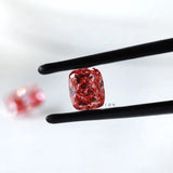 Fancy vivid pink cushion lab diamond pair in black tweezers