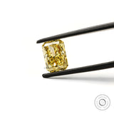Fancy intense yellow radiant cut lab diamond in tweezers