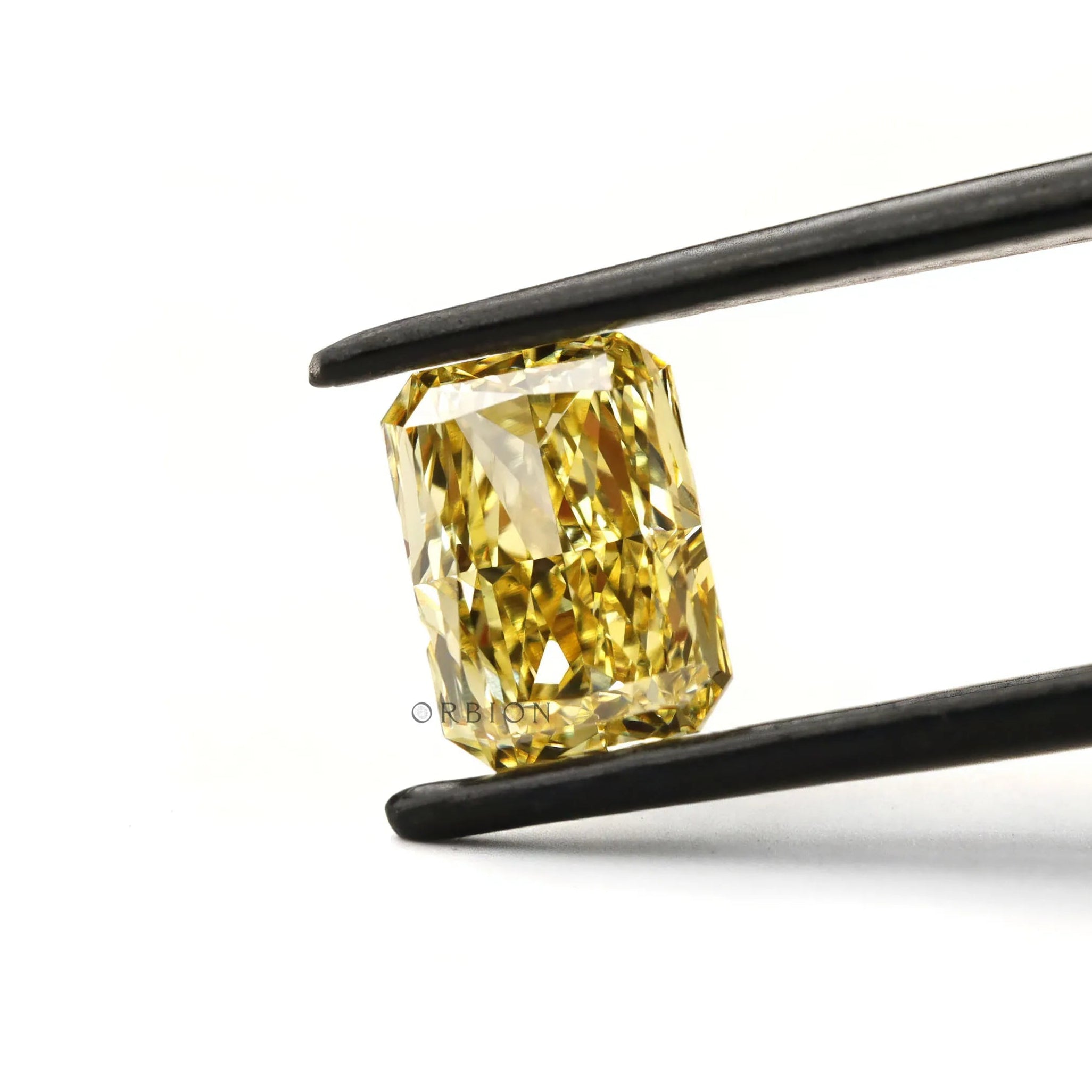 Fancy intense yellow radiant cut lab diamond in tweezers