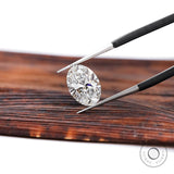 DEF oval lab diamond angled view in jeweler tweezers