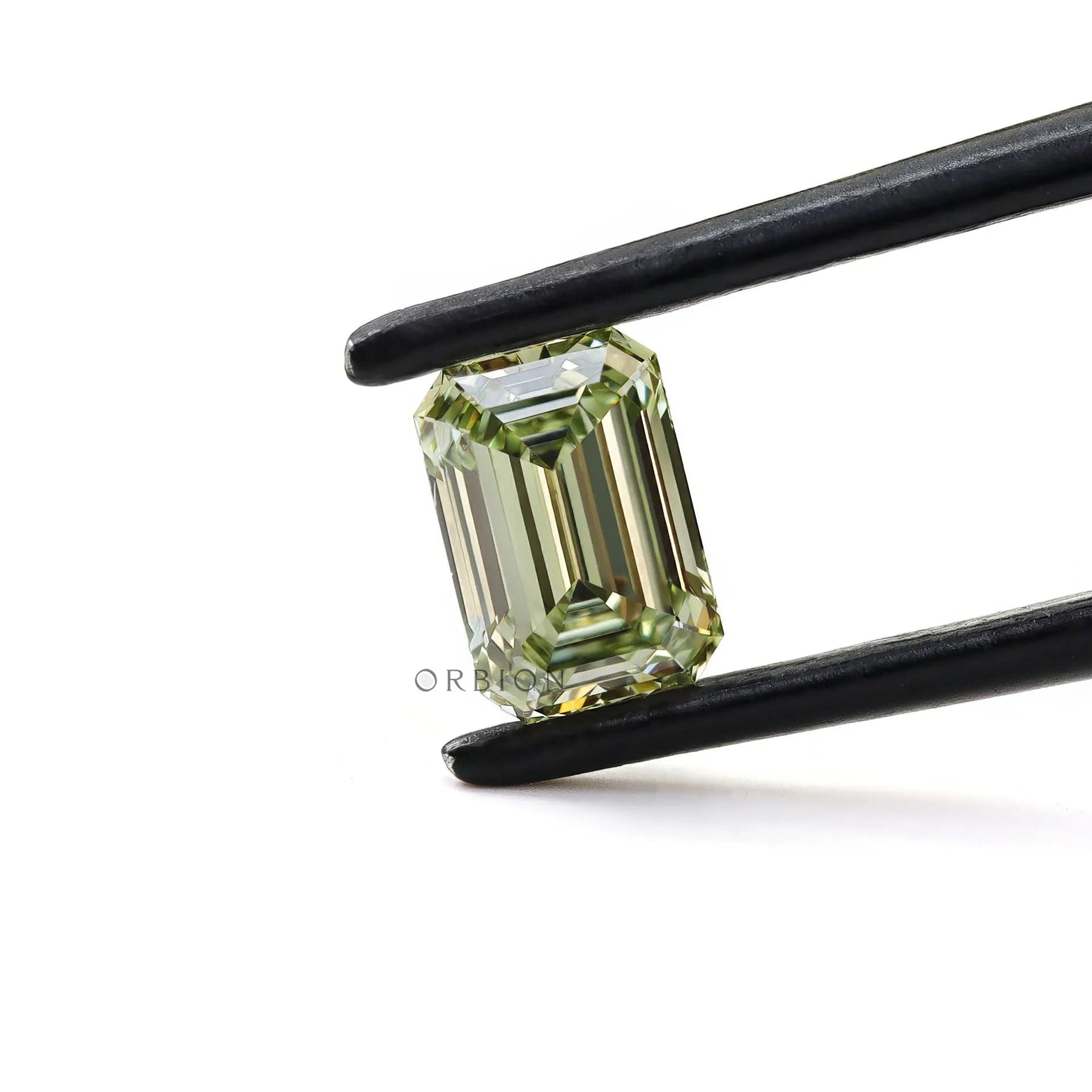 Fancy green emerald cut loose lab diamond in tweezers