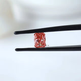Fancy vivid pink radiant diamond shown in tweezers