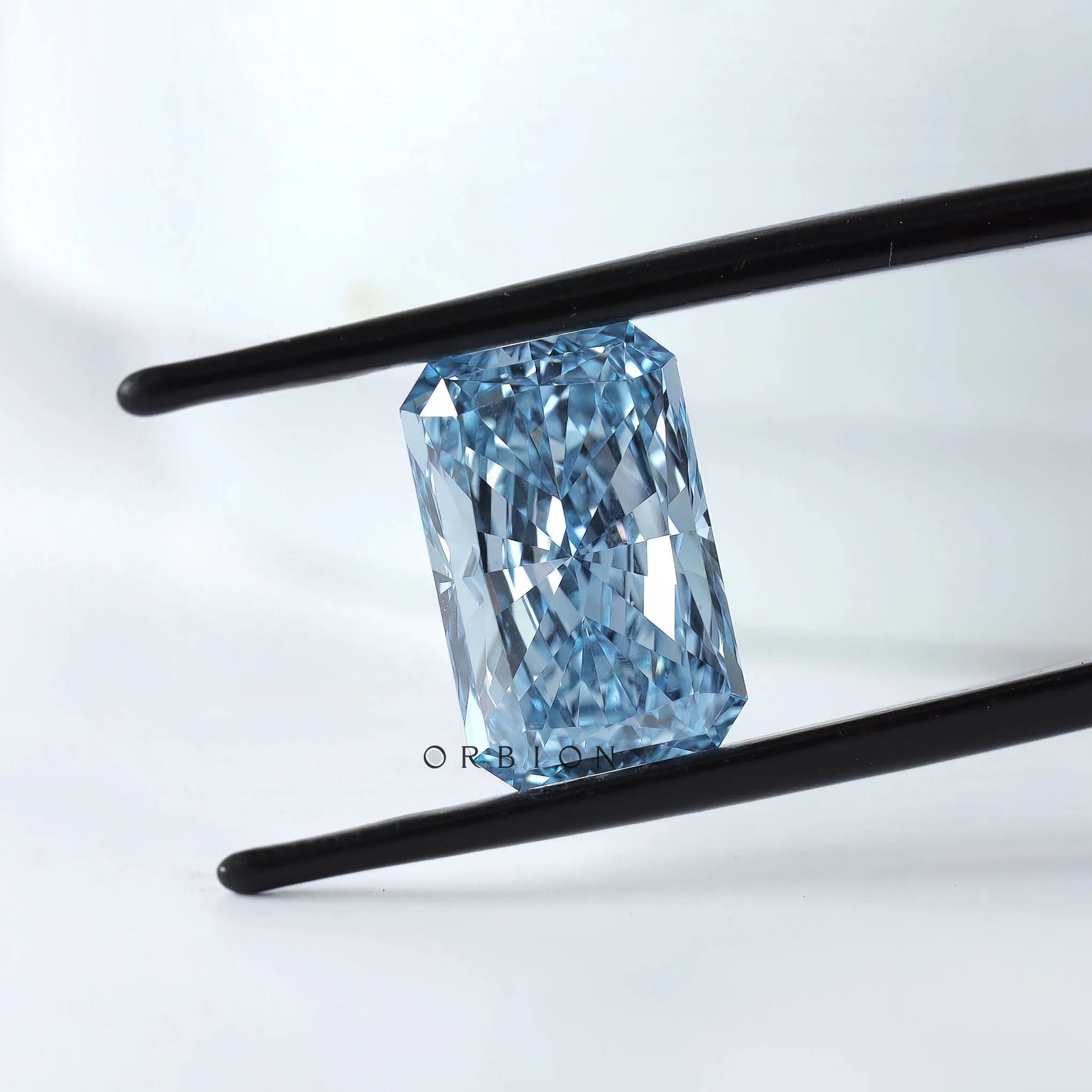 Angled view of radiant brilliant cut blue lab diamond