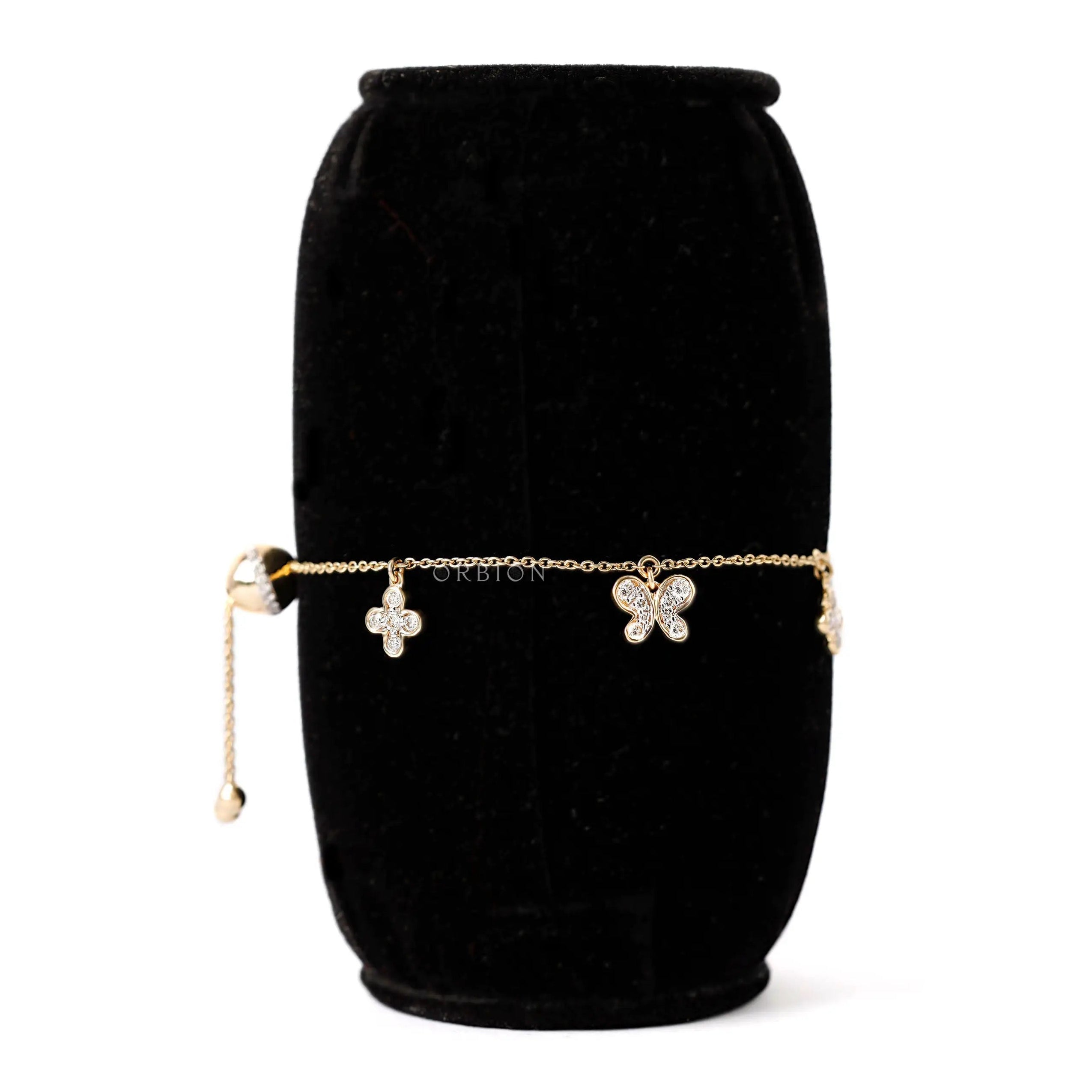 Angled view lab diamond butterfly and clover charm bolo bracelet