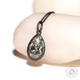 Angled view of old mine cut pear moissanite pendant