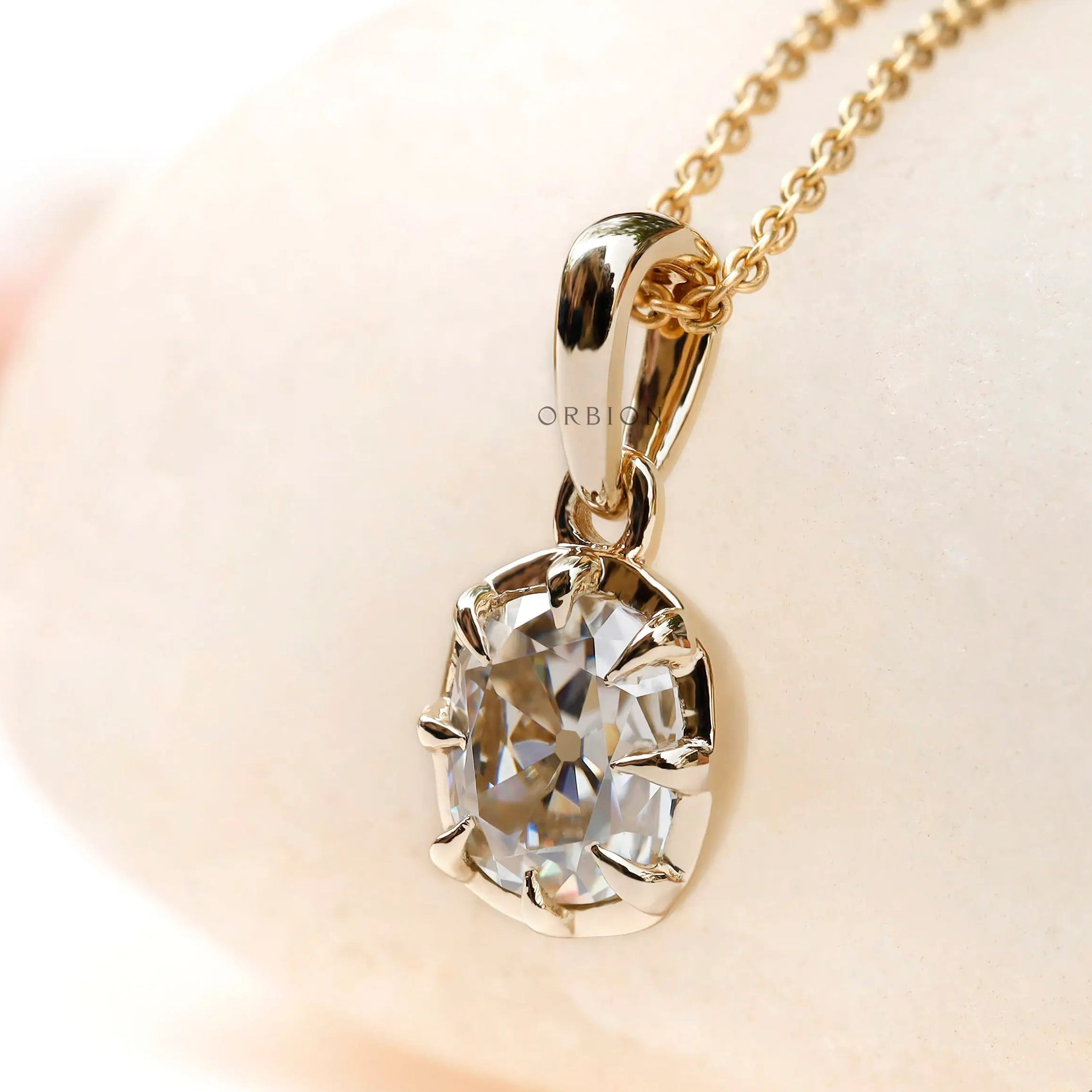 Angled view cushion old mine moissanite pendant yellow gold