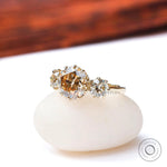Angled view champagne moissanite three stone yellow gold ring