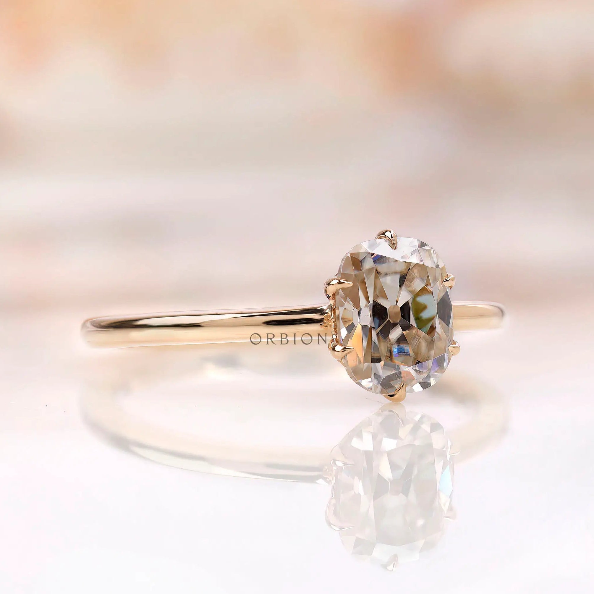 Angled front view of tulip set elongated cushion moissanite ring