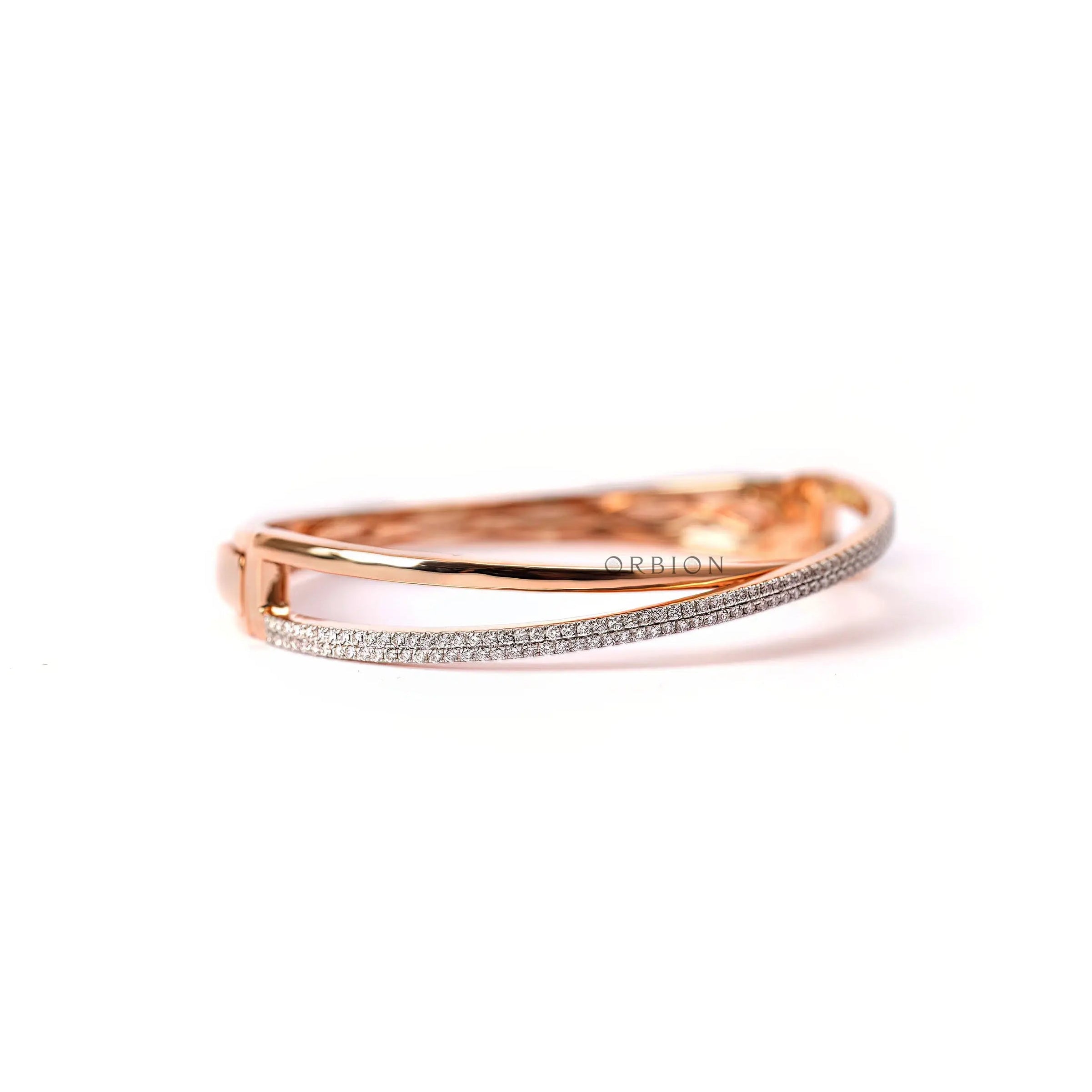 Angled view diamond crossover bangle bracelet in rose gold