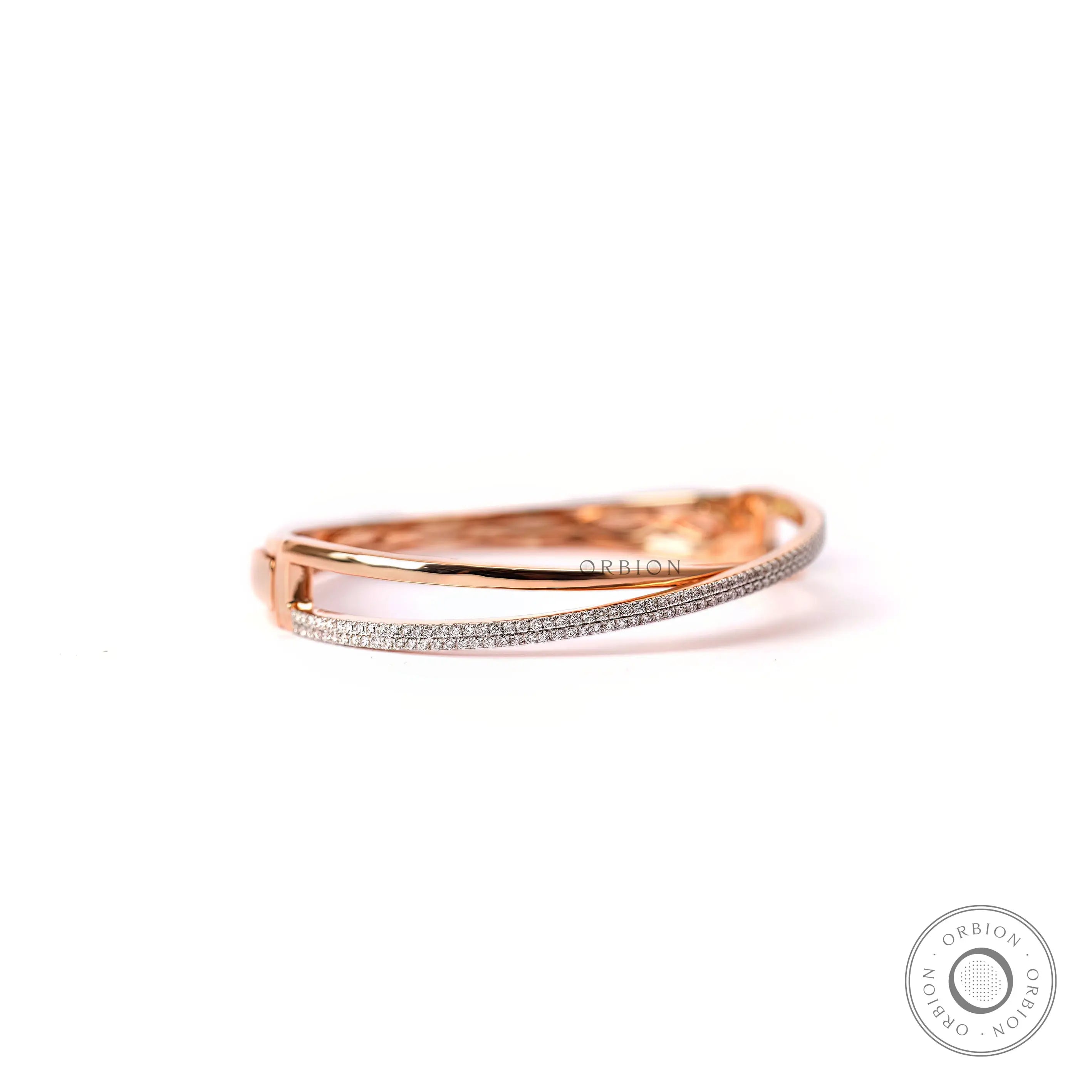 Angled view diamond crossover bangle bracelet in rose gold