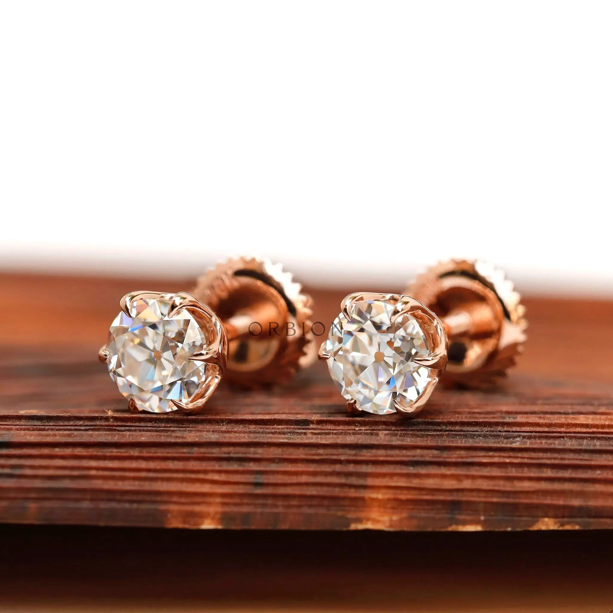 Angled front view rose gold moissanite stud earrings
