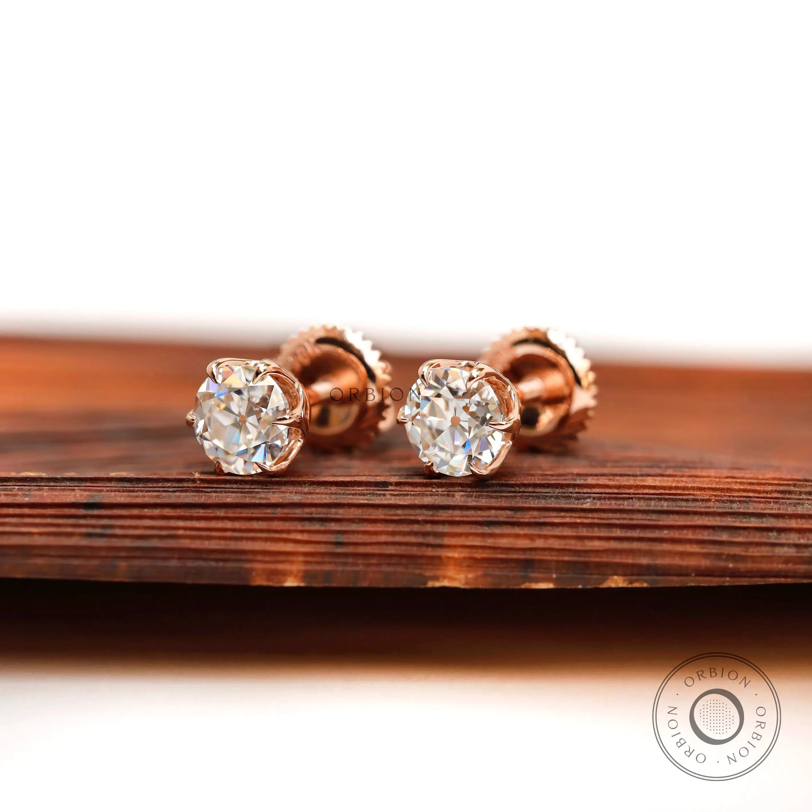 Angled front view rose gold moissanite stud earrings