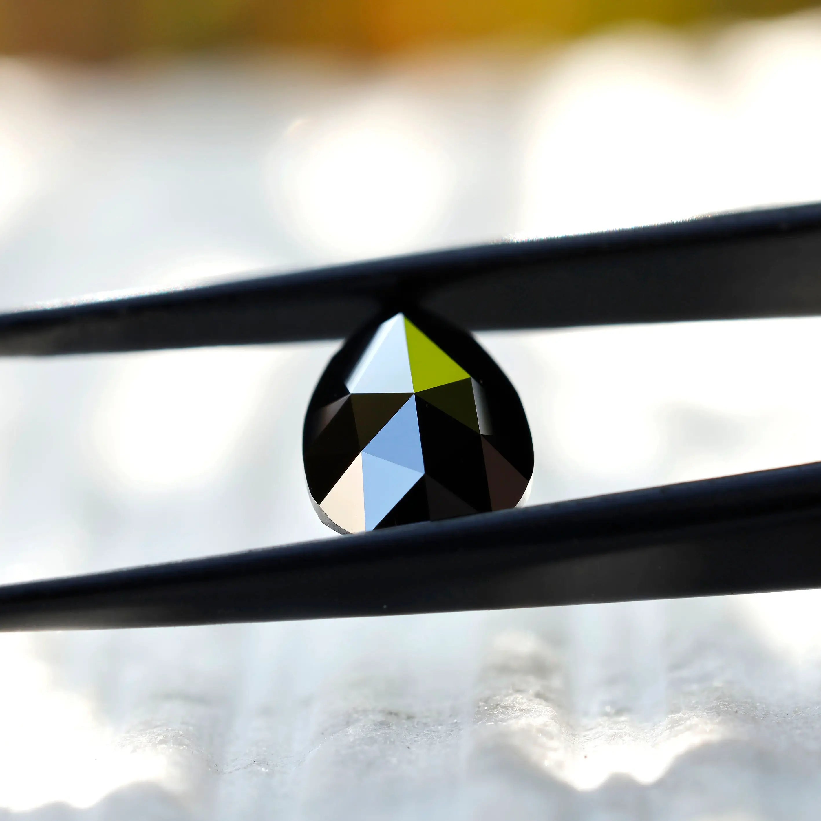 Close-up of black pear moissanite rose cut facet