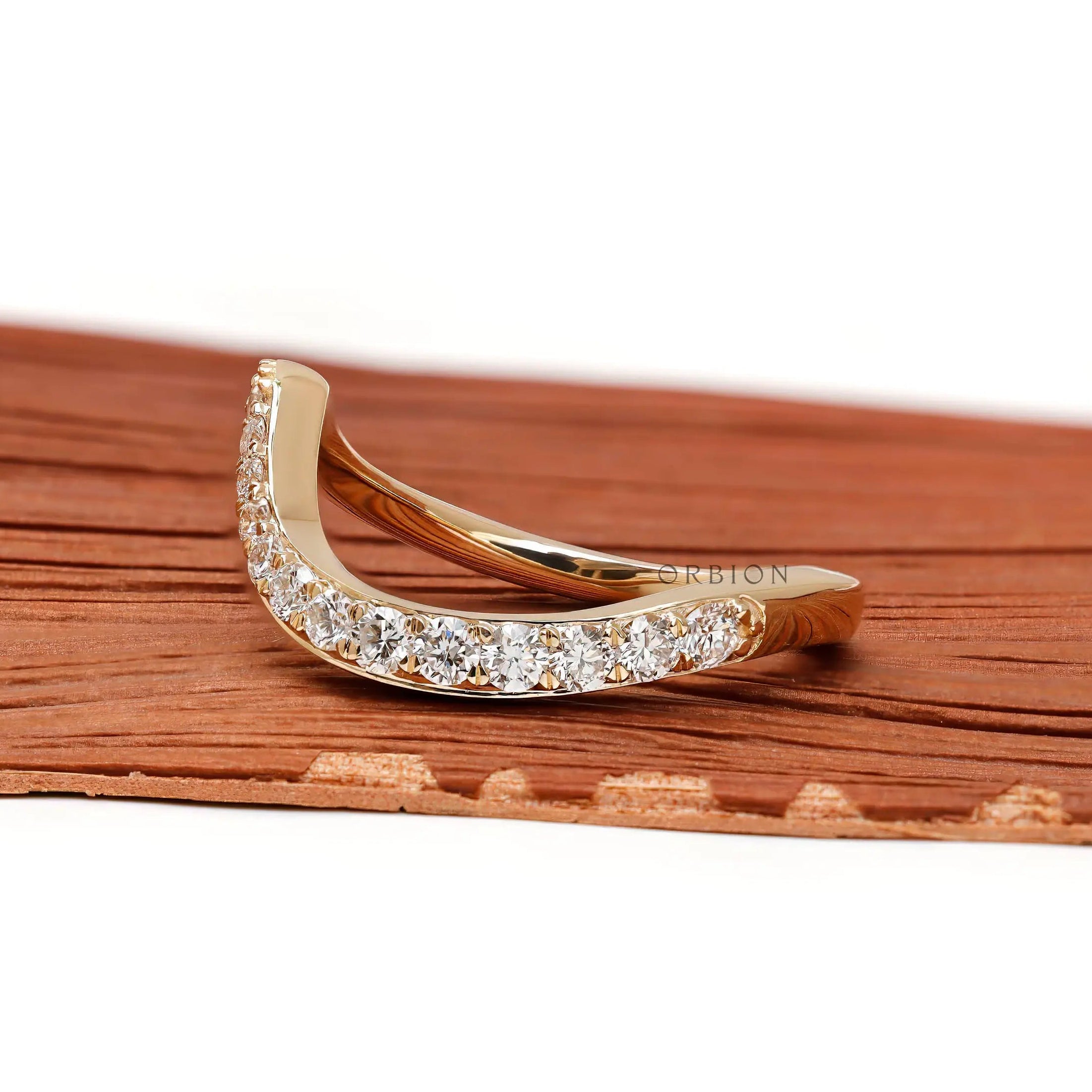 Curved diamond wedding band in 10K yellow gold