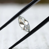 Close-up of marquise loose moissanite held in tweezers