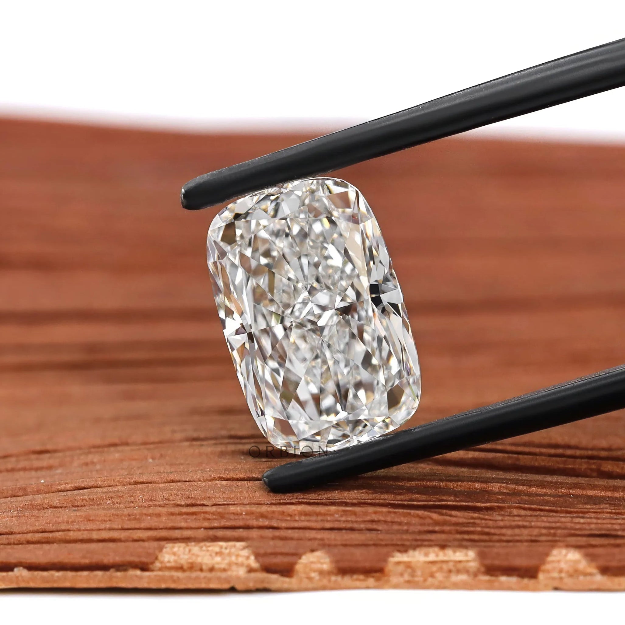 Close-up elongated cushion crushed ice loose lab diamond on wood