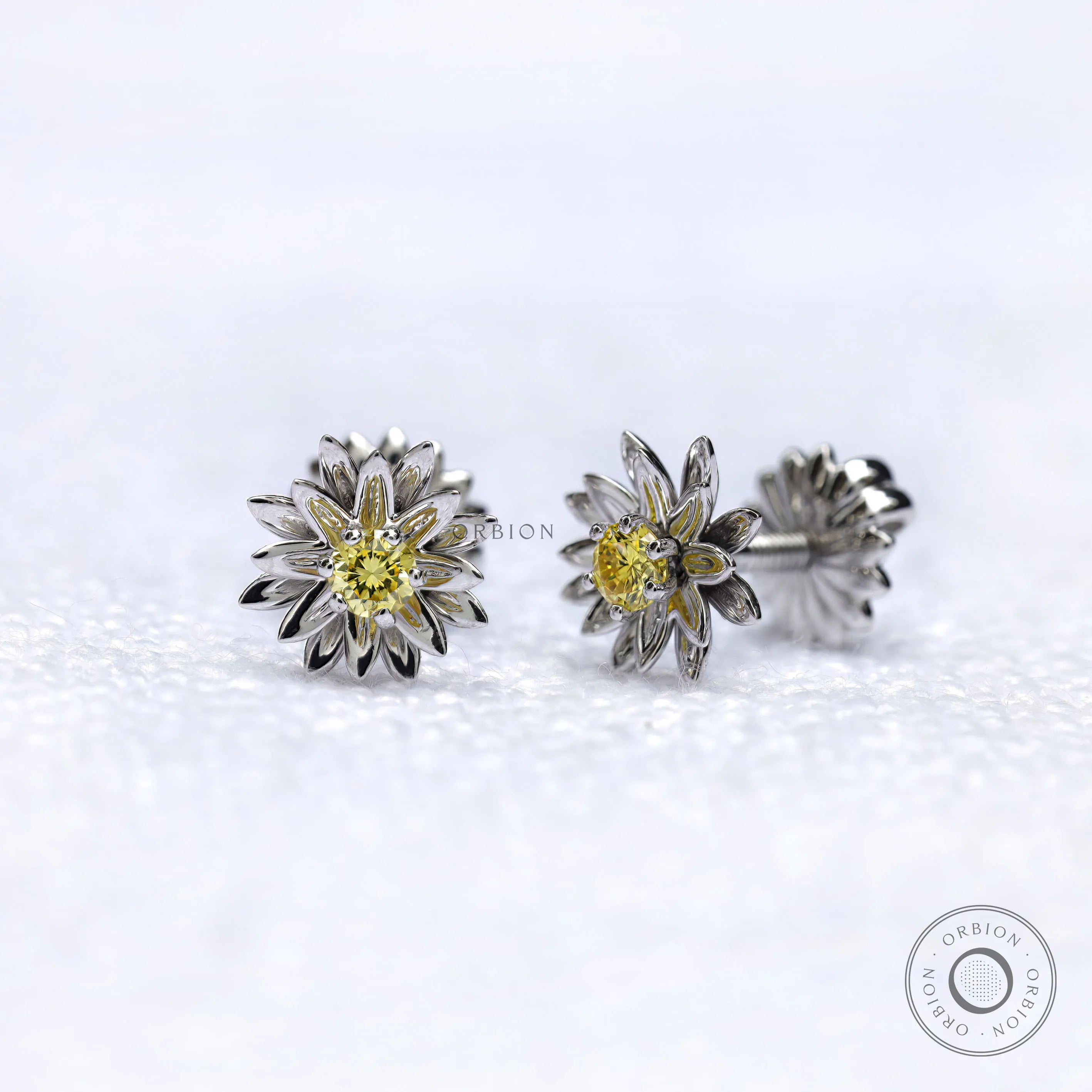 Side view of lotus flower stud earrings with yellow diamond.