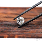 Close view of round lab diamond on wooden surface