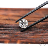 Close view of round lab diamond on wooden surface
