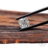 Close view of cushion lab diamond in black tweezers
