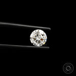 Close-up round nova cut lab diamond in black tweezers on black background