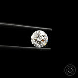 Close-up round nova cut lab diamond in black tweezers on black background