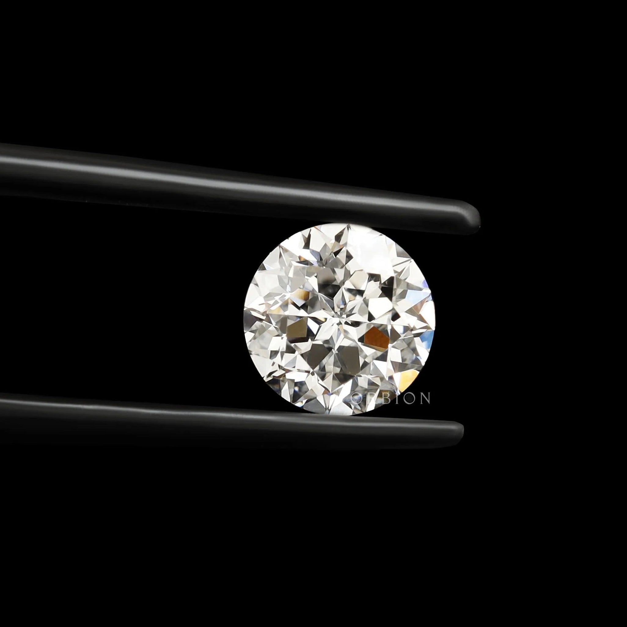 Close-up round nova cut lab diamond in black tweezers on black background