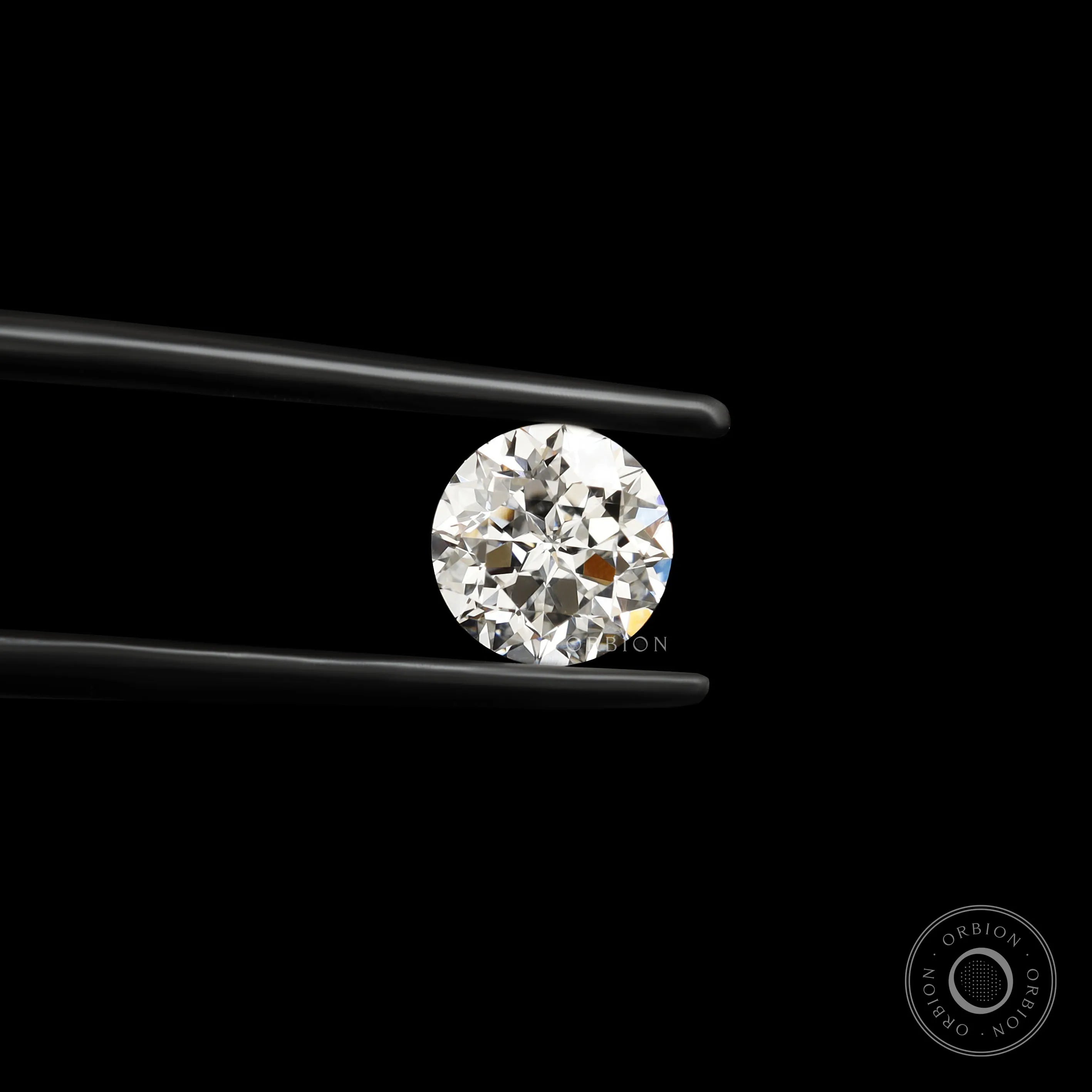 Close-up round nova cut lab diamond in black tweezers on black background