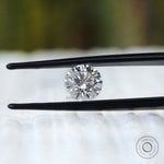 Colorless round lab diamond close up on white surface
