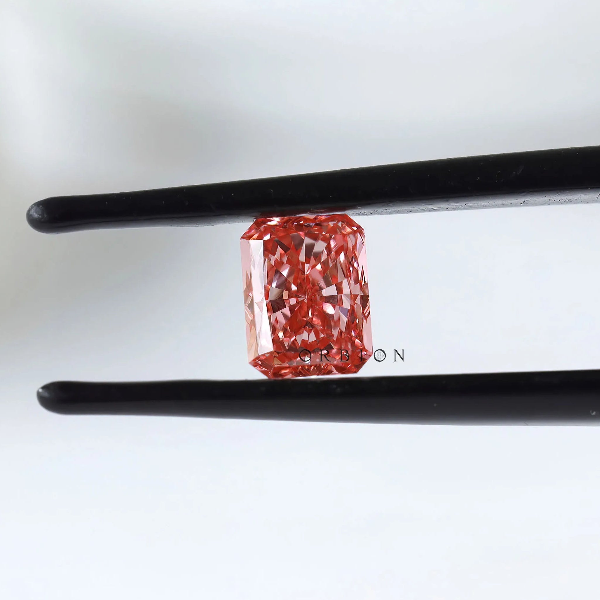 Close view of vivid pink radiant in tweezers