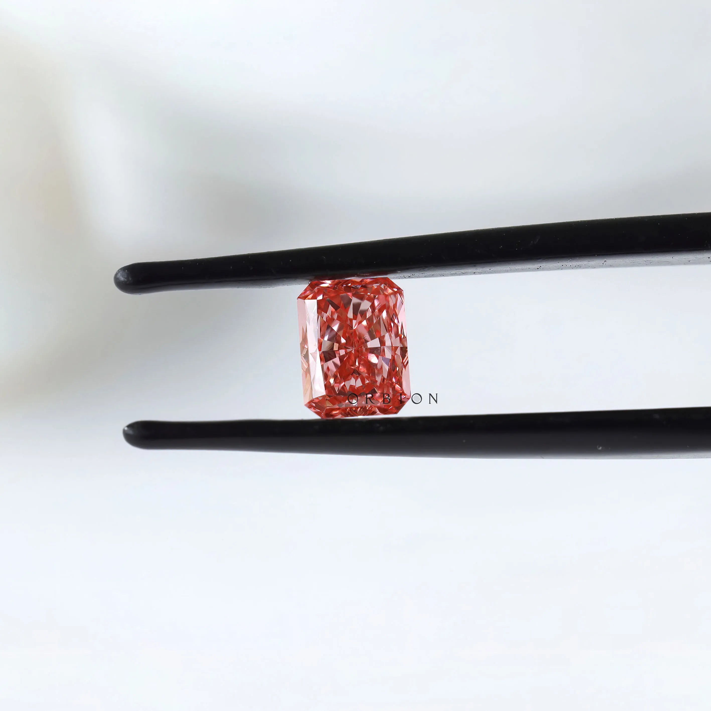 Close view of vivid pink radiant in tweezers