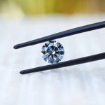 Angled close view of round blue brilliant lab diamond