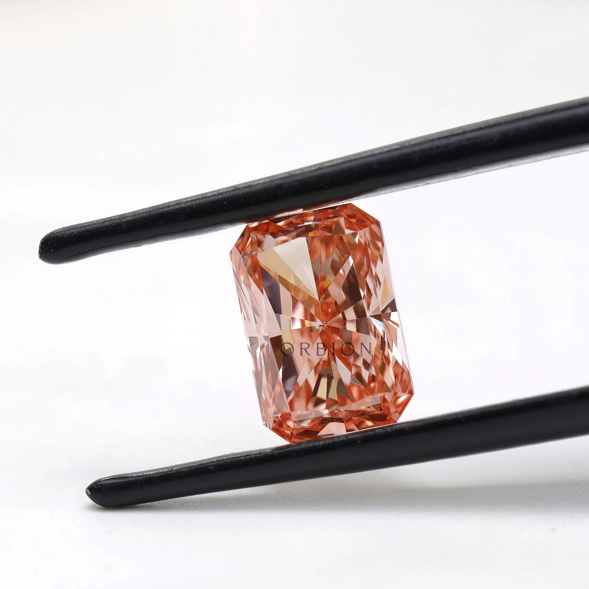 Angled close view of fancy pink radiant lab diamond